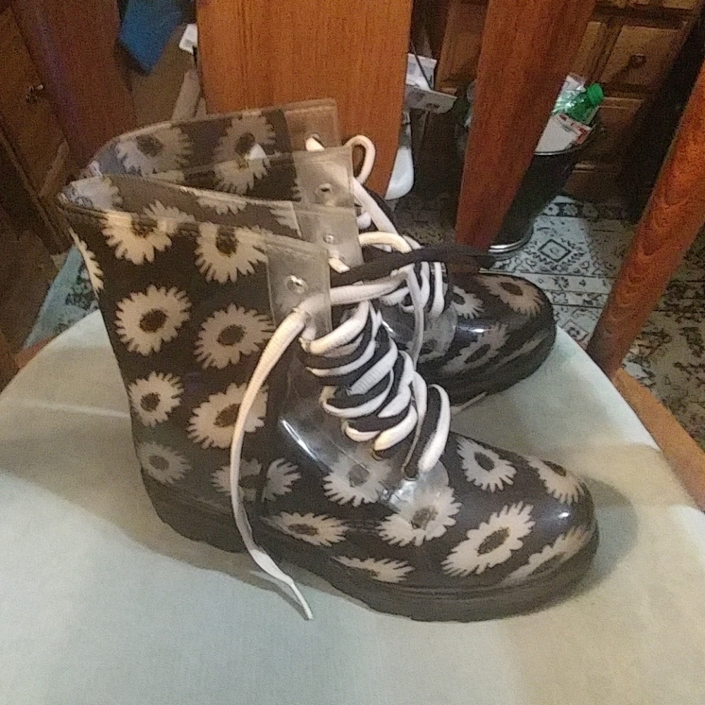Black rainboots with sunflowers on them